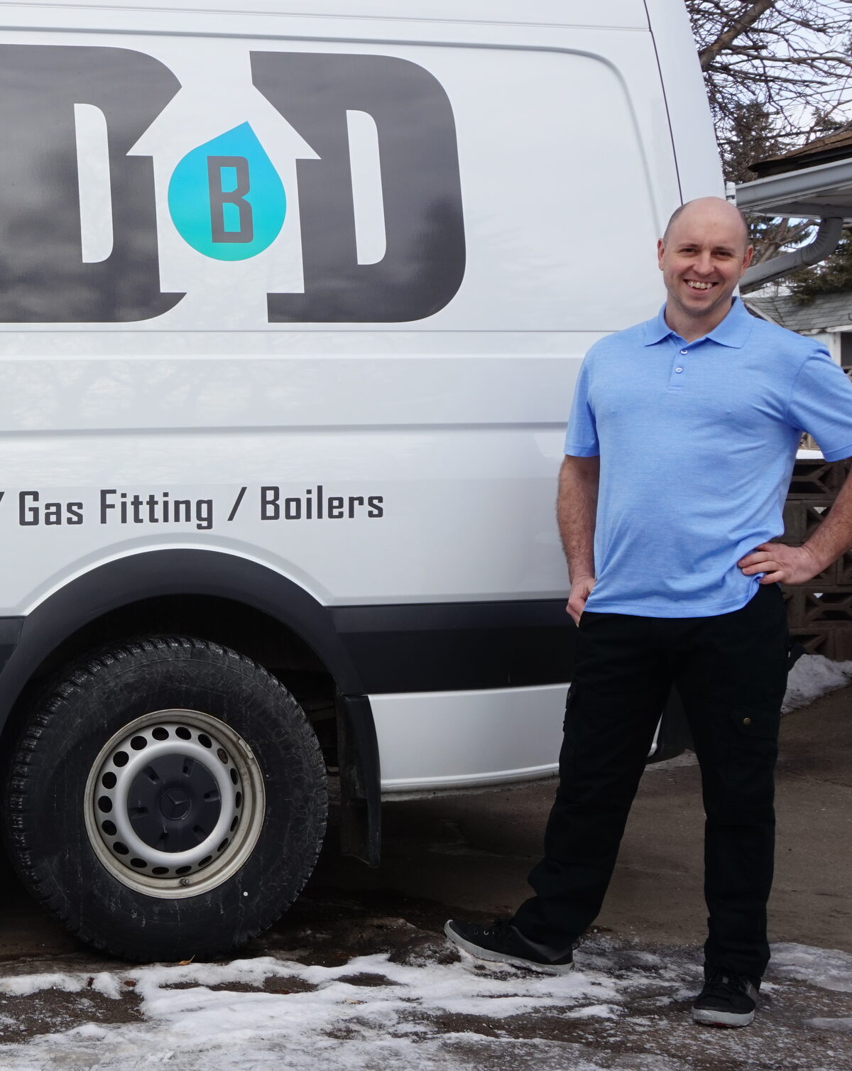 Daniel Walker standing beside his Done by Daniel service van