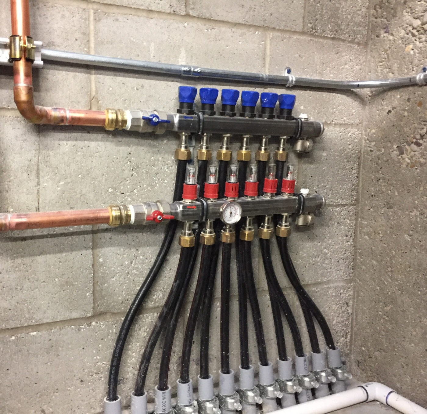 Radiant floor manifold with balanced loops, installed by Daniel